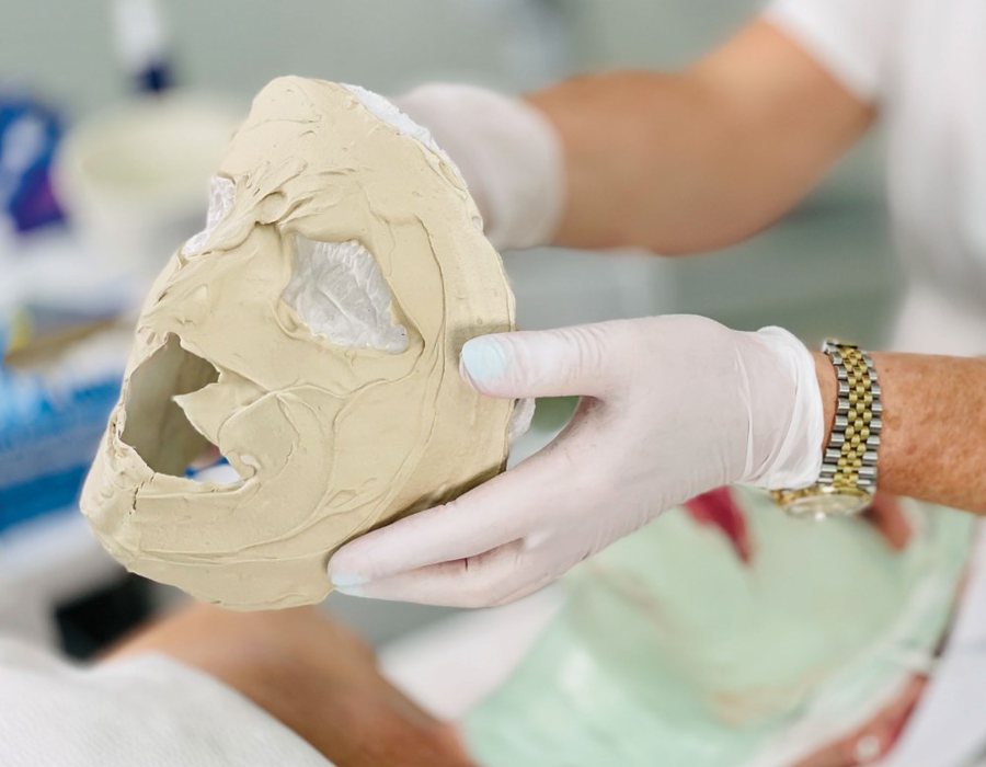 Professional lifting off the mineral mask in one piece at the end of the Four Layer Facial